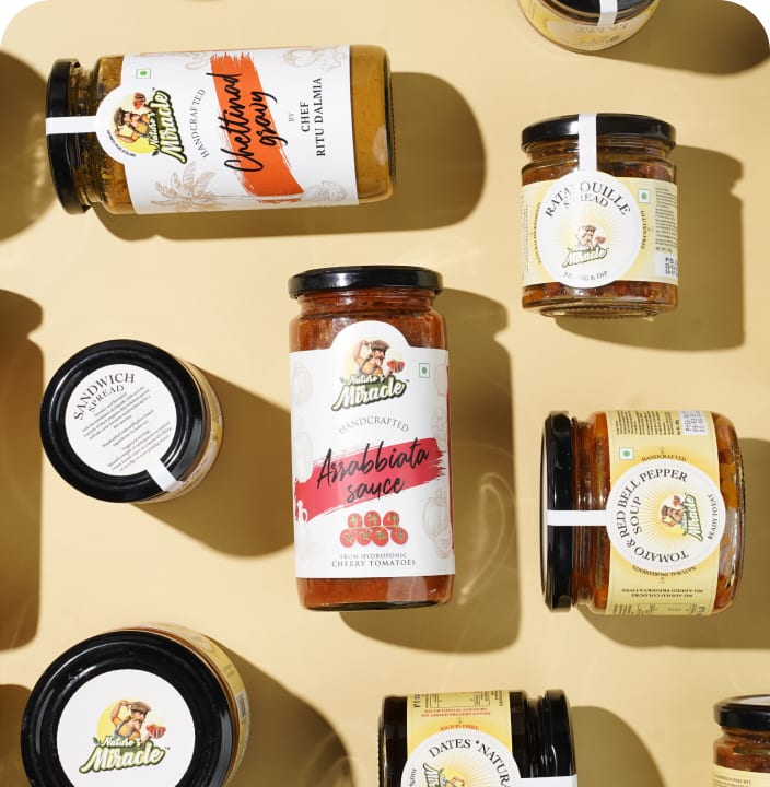 Nature&rsquo;s Miracle preserve and spread jars arranged on a warm beige surface
