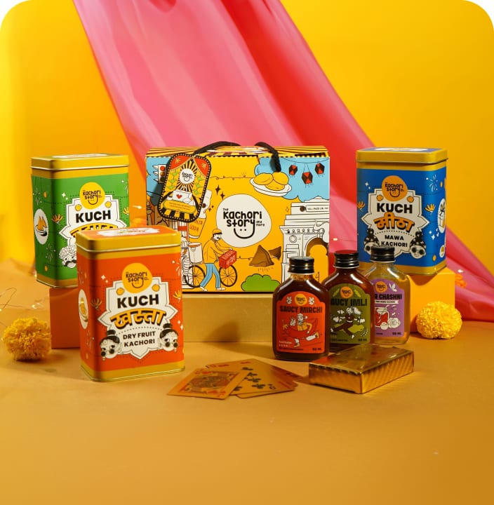 The Kachori Story festive tins and bottles staged against a pink drape